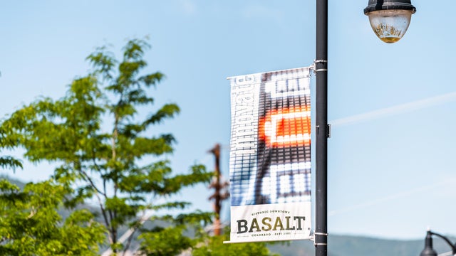 Sign banner on lamp post for historic downtown of small town city in outdoor summer street 