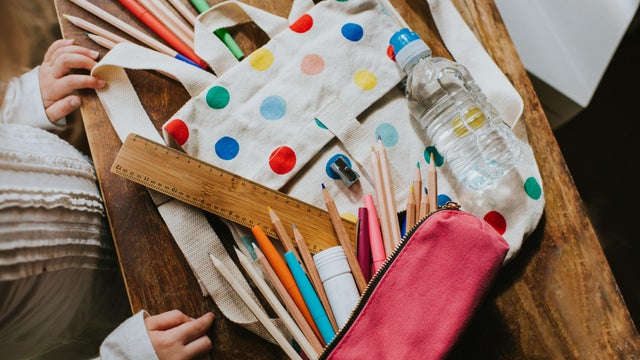 Child looking at a Spotty Schoolbag with Stationary Surrounding 