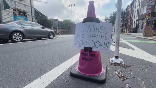 A cone with a sign that says 4 crashes in 2 weeks, slow down 