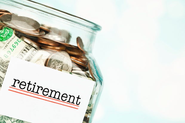 Money jar filled with American cash marked Retirement. Pension fund.