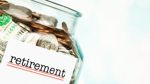 Money jar filled with American cash marked Retirement. Pension fund. 