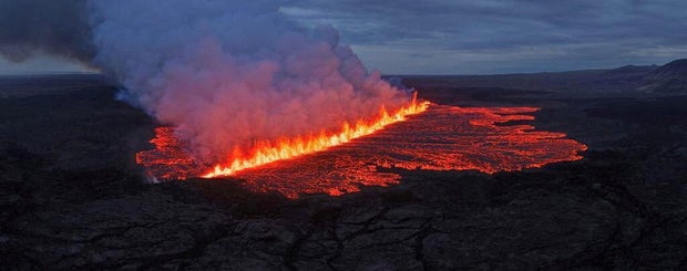 Lava emerges through a fissure following a volcano eruption near Grindavik