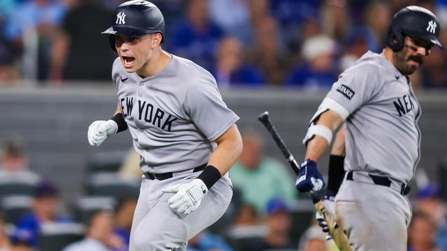 Ben Rice #22 of the New York Yankees celebrates at the plate with Austin Wells #28 as he hits a solo-home run in the ninth inning of their MLB game against the Toronto Blue Jays at Rogers Centre on July 22, 2025 in Toronto, Ontario, Canada. 