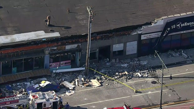 A collapsed facade outside a store in Queens 