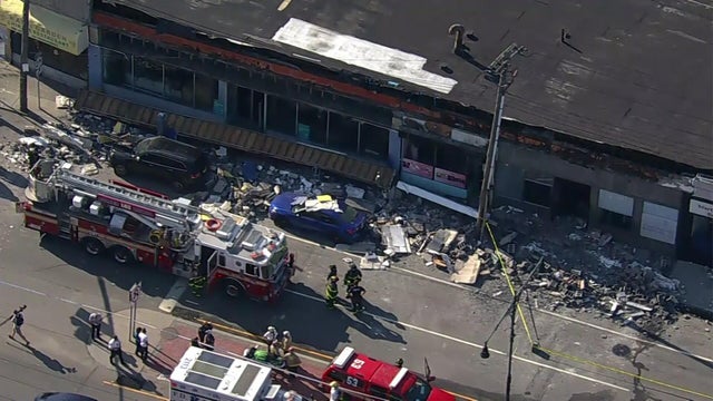 A collapsed facade outside a store in Queens 