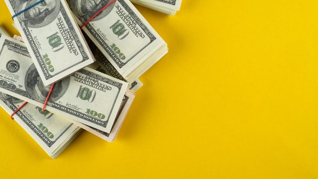 A banknote in US dollars in bundles On a bright background. The concept of finance and economics, investments. Salary, bribe, profit or credit funds. Space for copying. 