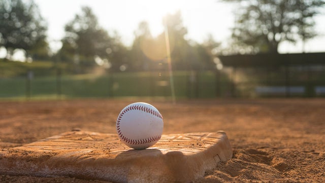Baseball in the Baseball Infield Backlit by the Sun 