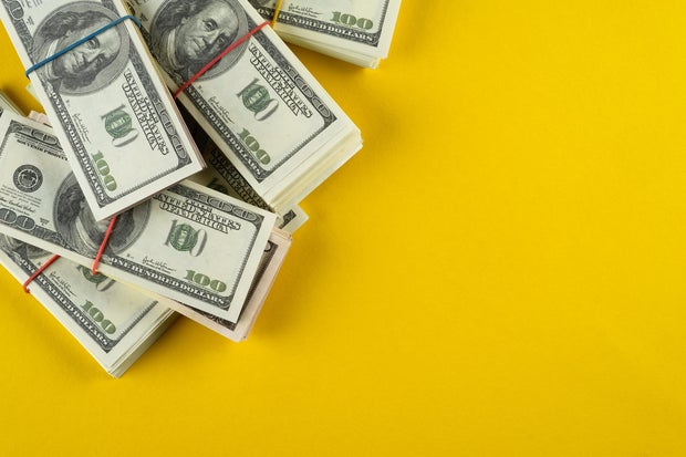 A banknote in US dollars in bundles On a bright background. The concept of finance and economics, investments. Salary, bribe, profit or credit funds. Space for copying. 