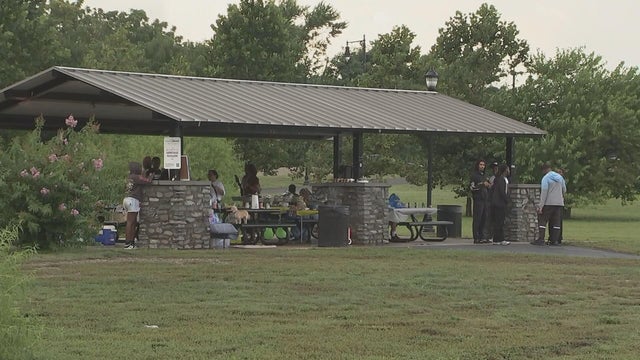 A family has a celebration under a pavilion at Cooper River Park 