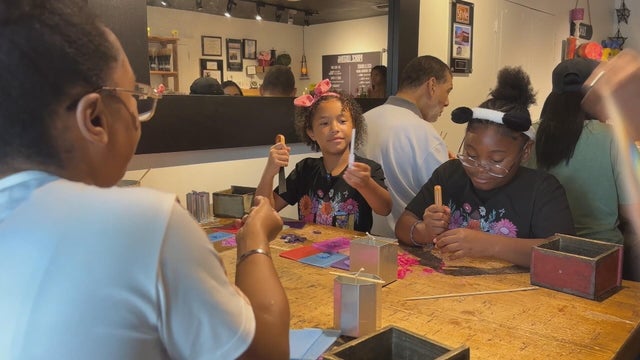 Two girls are working on making candles at Wax N Scent studio 
