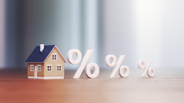 Miniature house Real Estate Trading and Percentage Signs, Mortgage Low and High Interest Concept Buying and Selling 