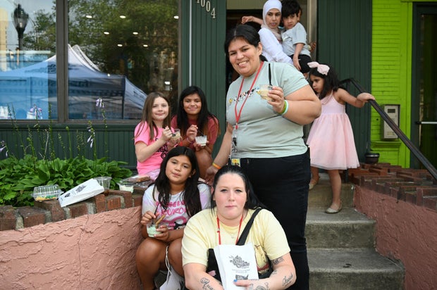 Kids and adults smile for a photo during the event