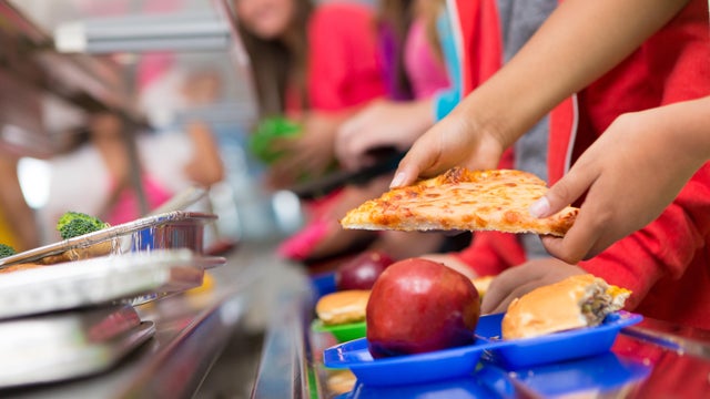 School children getting food in the cafeteria line 