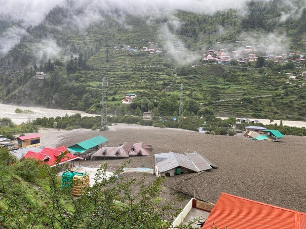 Houses are partially buried by a mudslide, amid flash floods, in Dharali, Uttarakhand, India, Aug. 5, 2025. 