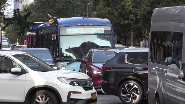 A New York City bus stuck in traffic on 34th Street 