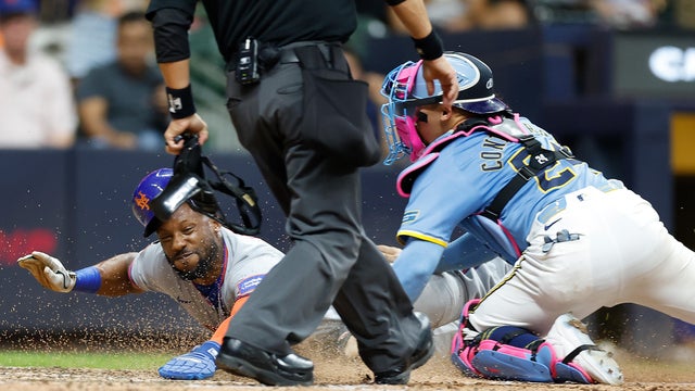 Starling Marte #6 of the New York Mets is tagged out at home plate by William Contreras #24 of the Milwaukee Brewers to end the game at American Family Field on August 08, 2025 in Milwaukee, Wisconsin. 