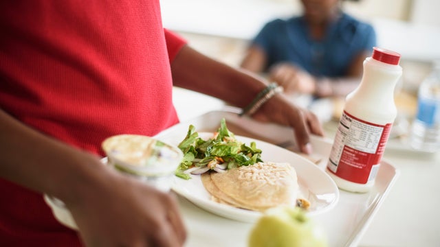 Black students eating lunch in school cafeteria 