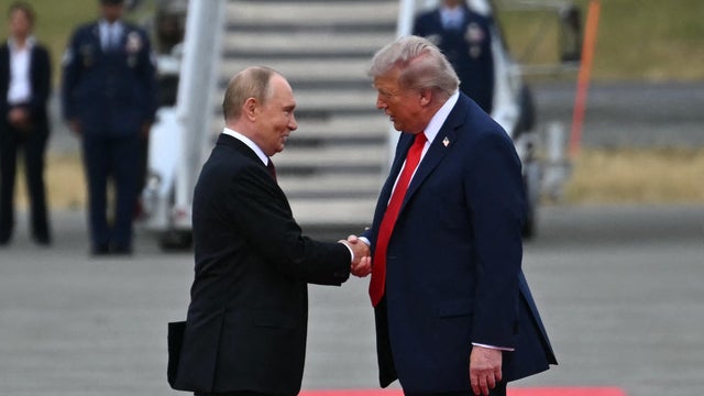 President Trump shakes hands with Russian President Vladimir Putin 