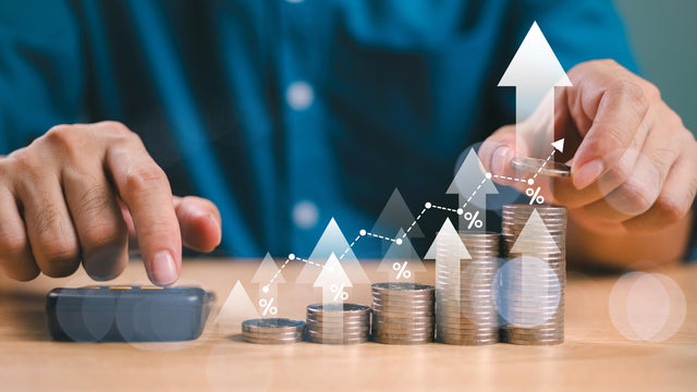 Money interest rate increase concept, percentage commission credit. Grow up stock risk management. Bank policy price raise. Businessman with coin, calculate high percentage of company profit dividend 