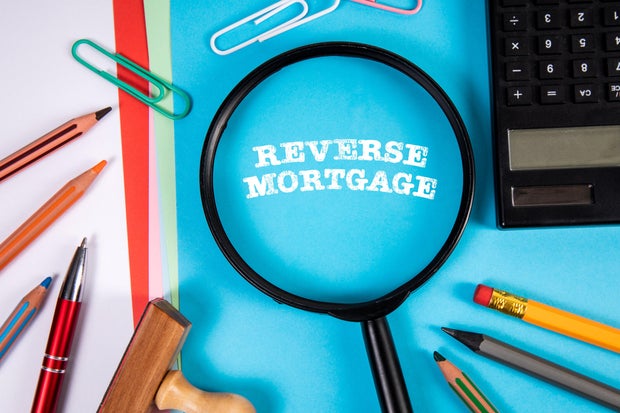 Reverse Mortgage. Magnifying glass and stationery on the office table 