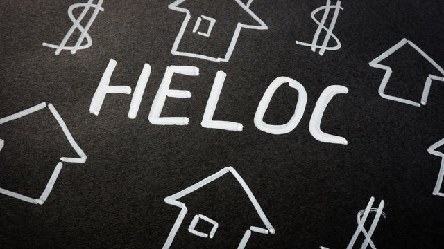 HELOC home equity line of credit loan and homes on the black sheet. 