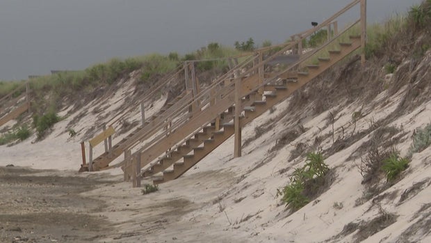 Stairs on a beach lead to nowhere due to erosion