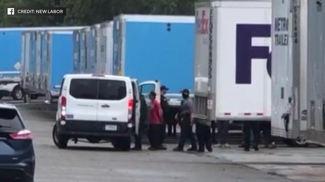 Warehouse workers are placed in a van by federal agents 
