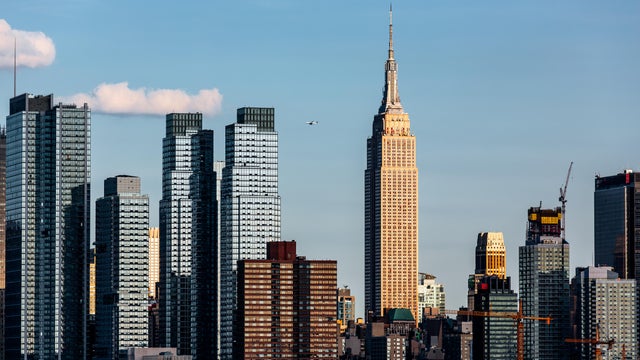 Manhattan skyline with Empire State Building on a sunny day with clear blue sky, New York City, USA 