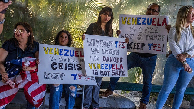 Venezuelans held posters during a vigil in Doral, Florida, in support of the extension of the TPS for Venezuelans on Thursday, May 8, 2025. 