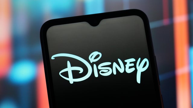 In this photo illustration, the Disney logo is seen 