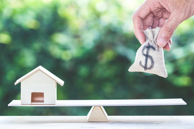 Balance home and money, home loan, reverse mortgage concept. 