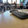 A cellphone locked in a pouch on a desk 