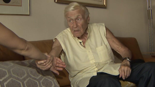 Lawrence Schwartz demonstrates how he twisted the arm of a woman who allegedly tried to steal his Rolex.