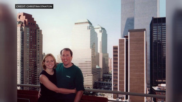 Christina Stanton and her husband on a terrace with the Twin Towers in the background 