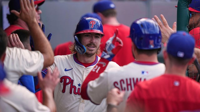 Phillies' Bryson Stott gets high fives from his teammates after hitting a home run during a game against the Royals at Citizens Bank Park 