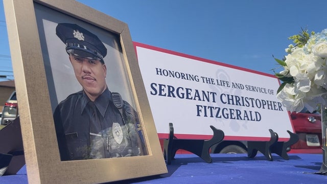 A portrait of Fitzgerald and a sign with his name at the ceremony 