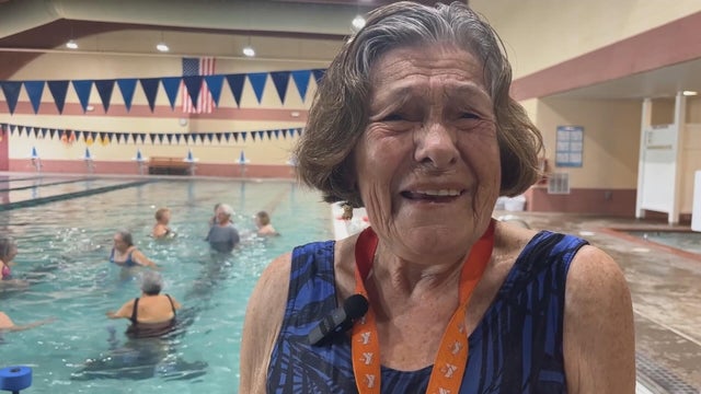 Joann Arnold smiles during an interview near the pool where she teaches fitness classes 