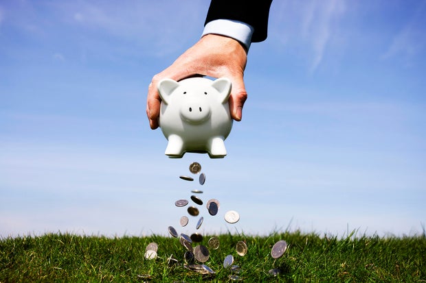 Businessman shaking a piggy bank