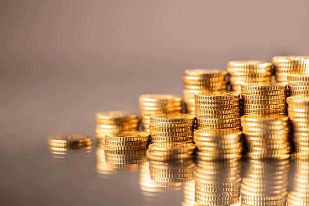 Pile of stacked shiny golden Euro coins close-up 