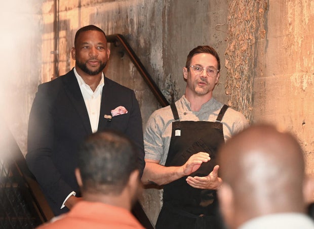 People pose for photos during the KB Foundation's BBQ Experience event