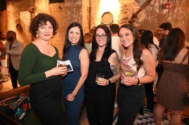 People pose for photos during the KB Foundation's BBQ Experience event