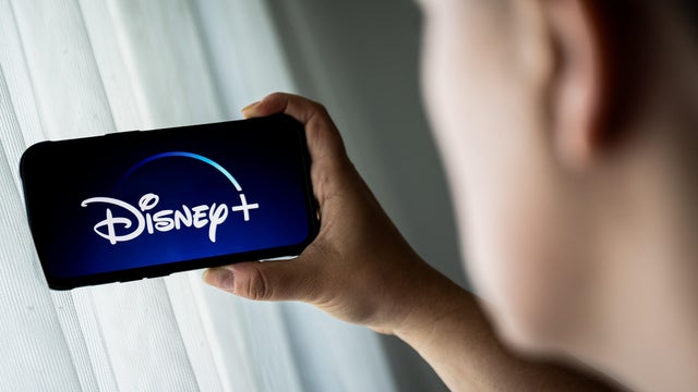 In this photo illustration, a Disney + logo is seen 
