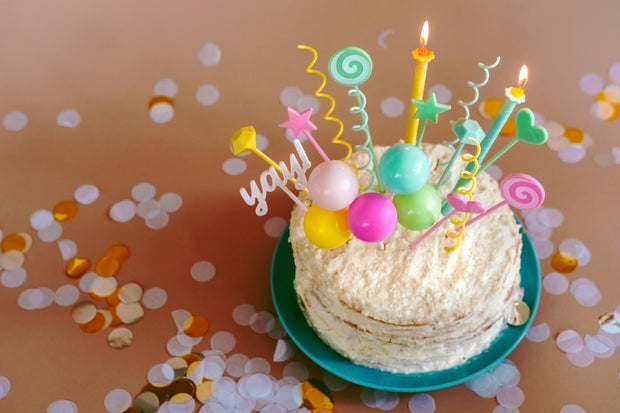 Festive celebration cake with colorful candles and decorations for birthday party or celebration