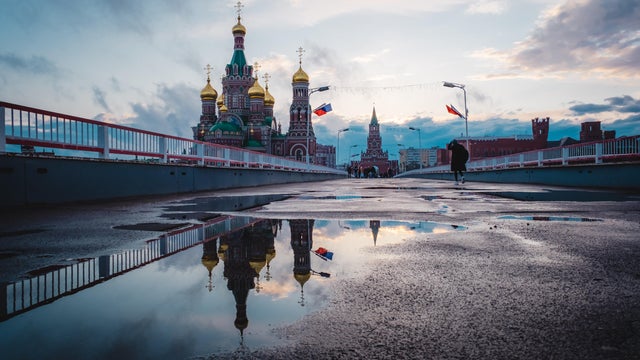 Yoshkar-Ola, Mari El, Russia. City architecture.View of the Spasskaya Tower reflected in a puddle 