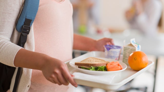 USA, New Jersey, Jersey City, Female student carrying tray in cafeteria 
