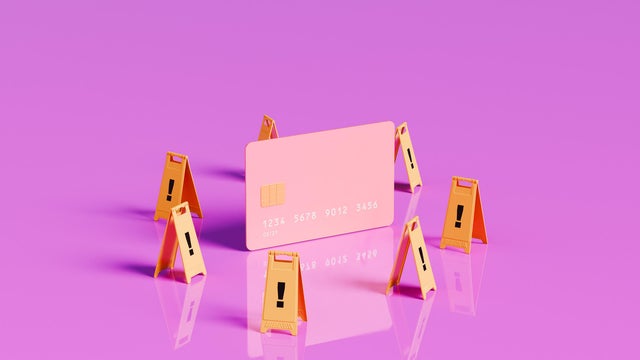 Caution Ahead - Oversized Credit Card with Surrounding Warning Signs 