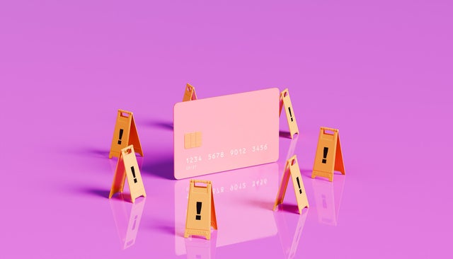 Caution Ahead - Oversized Credit Card with Surrounding Warning Signs 