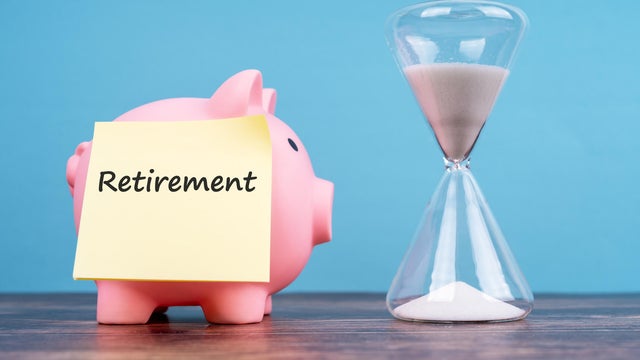 Retirement Text on Adhesive Note, Piggy Bank and Hourglass 