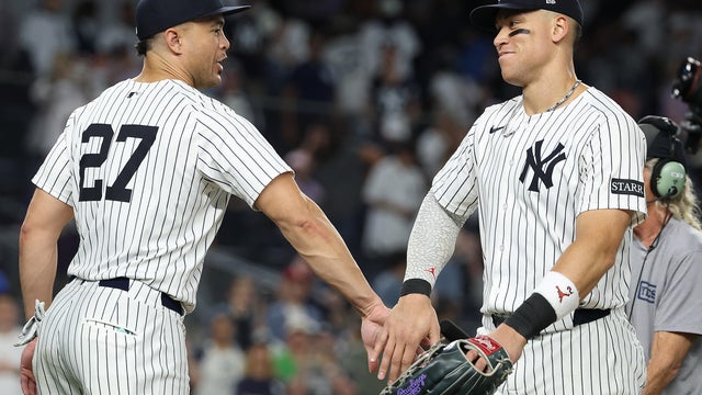 Giancarlo Stanton #27 and Aaron Judge #99 of the New York Yankees celebrate an 8-4 win against the Baltimore Orioles after their game at Yankee Stadium on September 26, 2025 in New York City. 