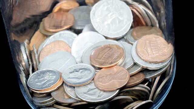 Coin collection in a glass jar 